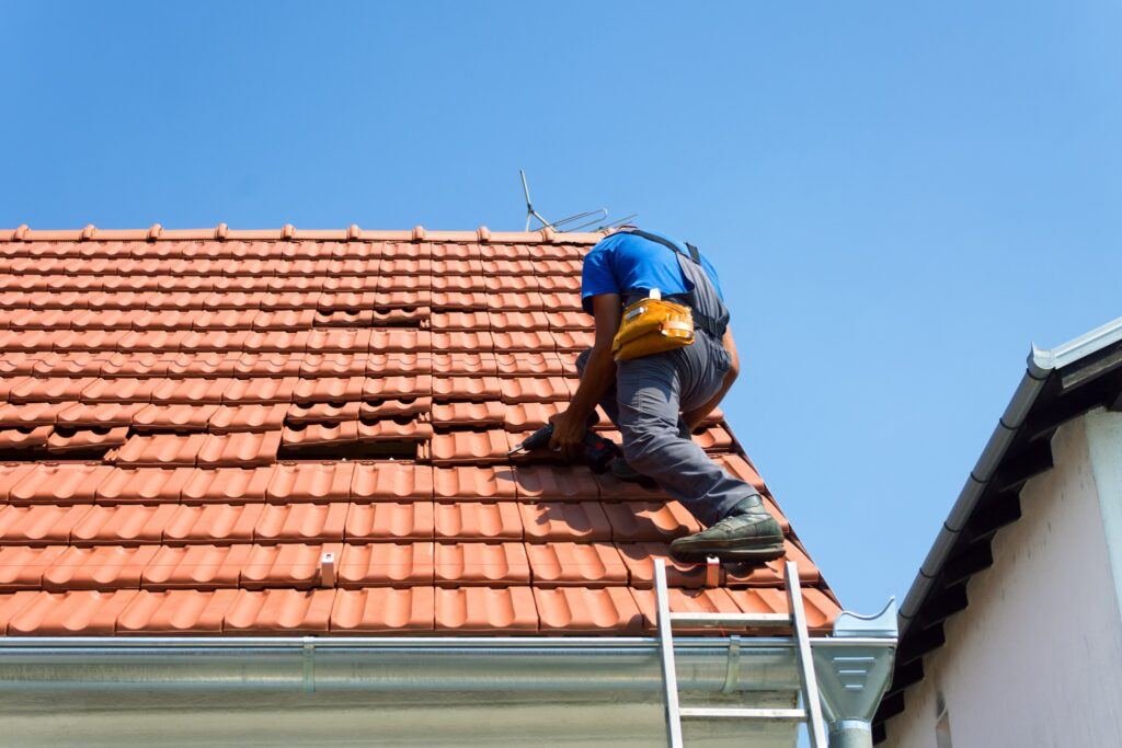 Guy Roofing a House